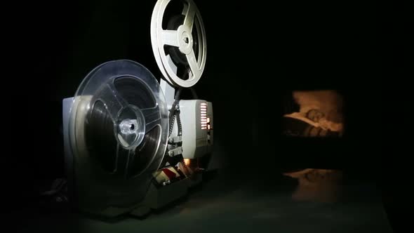 Old Projector Showing Film On Screen - Dolly Shot 2