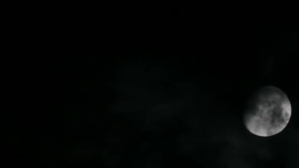Moon Moving Between Clouds 1 alt