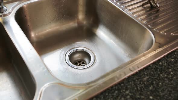 Water Flowing Down The Drain In Kitchen Sink 2