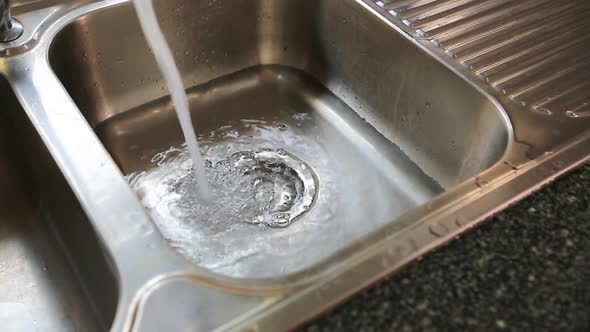 Water Flowing Down The Drain In Kitchen Sink 1