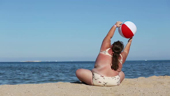 Overweight Woman Doing Gymnastics On Beach alt
