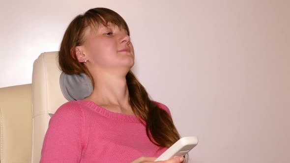 Young Woman Massaged Into Modern Automatic Massage Chair 3