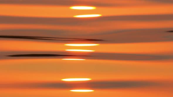 Reflection Of Sunrise On Water Surface