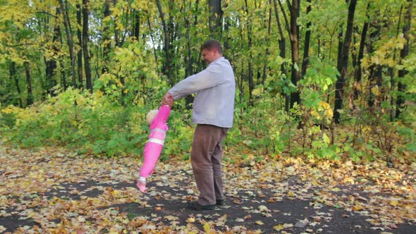 Father Playing  Baby In Autumn Park 2