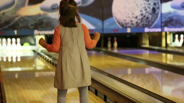 Bowling - A Little Girl Knocks Down Pins And Very Glad