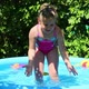 Cheerful Girl In Inflatable Pool In Summer Garden 2 - VideoHive Item for Sale