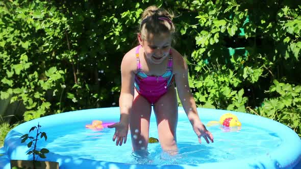 Cheerful Girl In Inflatable Pool In Summer Garden 2