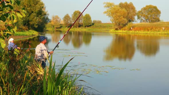 Fishing Senior Couple On Autumn Lake -