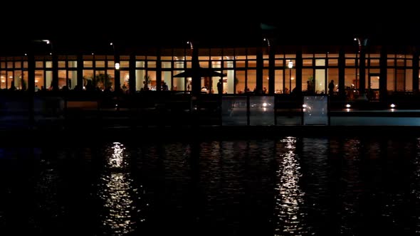 Night View Of The Restaurant By The Pond