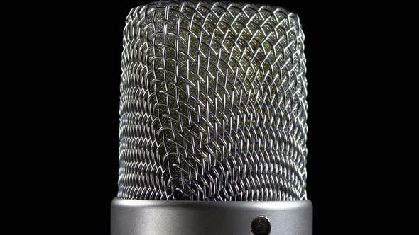 Studio Condenser Microphone Rotates on a Black Background