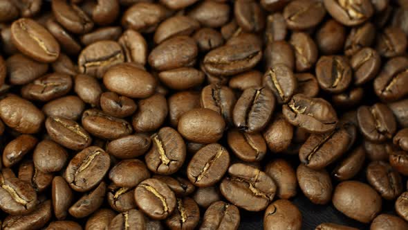 Rotation close-up of coffee beans 360. Golden selected aromatic beans rotates