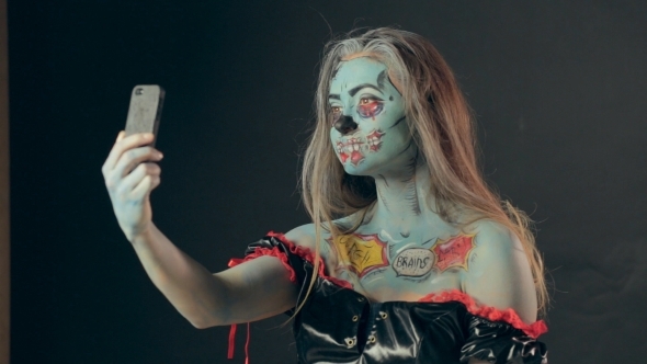 Girl In Makeup Of Dreaded Zombie Making Selfie