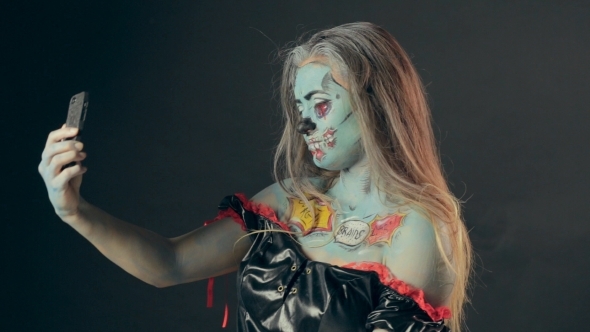 Girl In Zombie Makeup Makes Selfie Phone In Studio