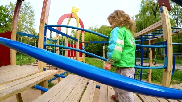 Happy Child Walking On Big Slide