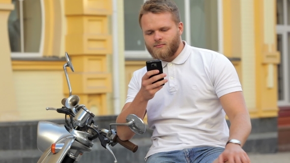 Bearded Man Sitting In Scooter
