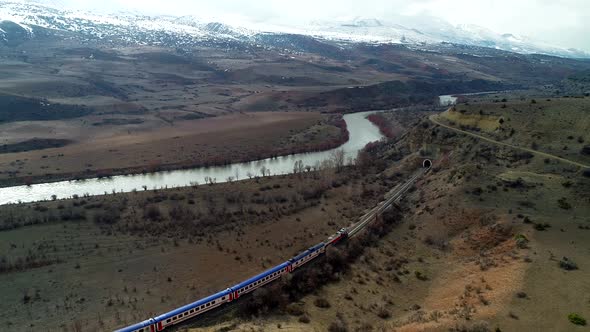Train Enters a Tunnel Near the River