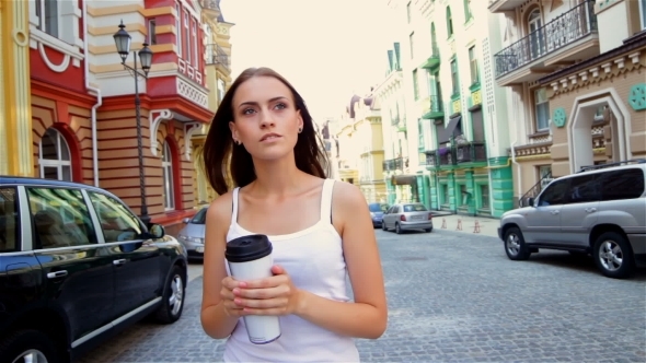 Girl Walking In The Town With Go Cup