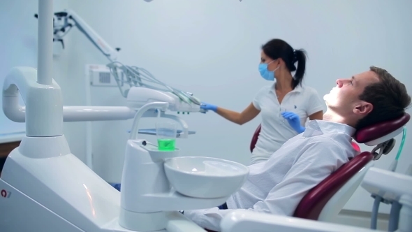 Attractive Dentist Preparing To Work With Patient