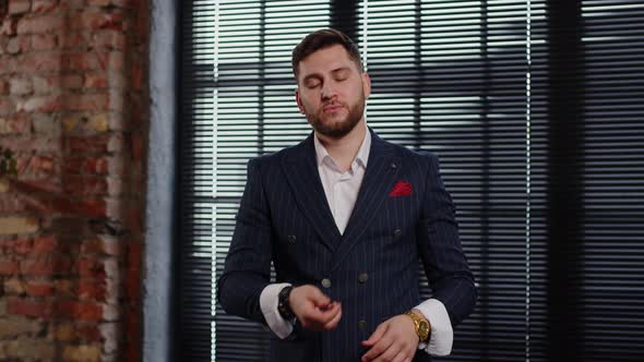 Crypto Millionaire in an Expensive Suit Flips a Bitcoin Coin and Shows It