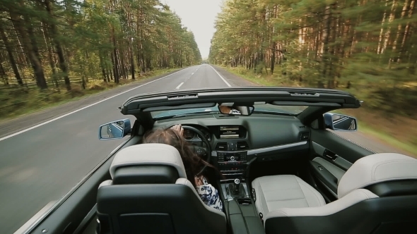 Female Driving a Luxury Open Top Car