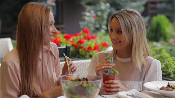 Girlfriend In a Cafe Drinking a Cocktail