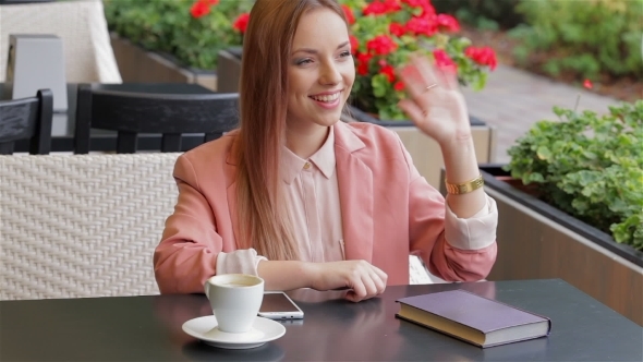 Girl Waving Hand In Cafe