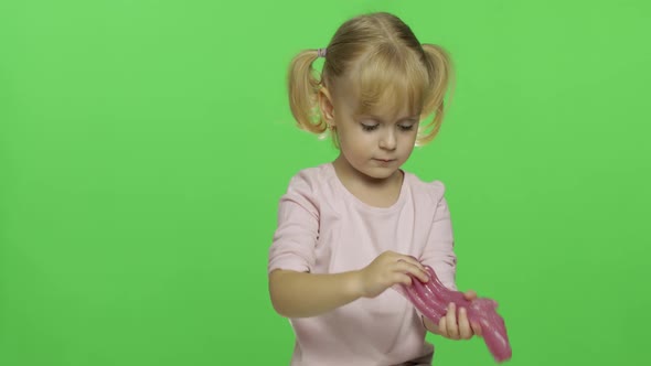 Kid Playing with Hand Made Toy Slime. Child Having Fun Making Pink Slime