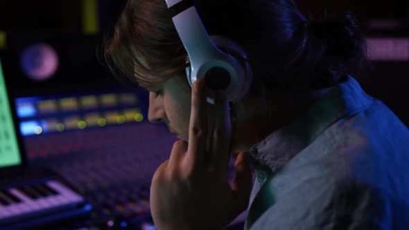 Male sound engineer working at a mixing desk