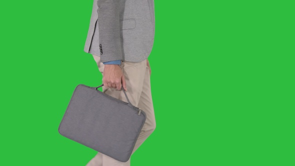 Man in casual walking with briefcase on a Green Screen, Chroma Key.