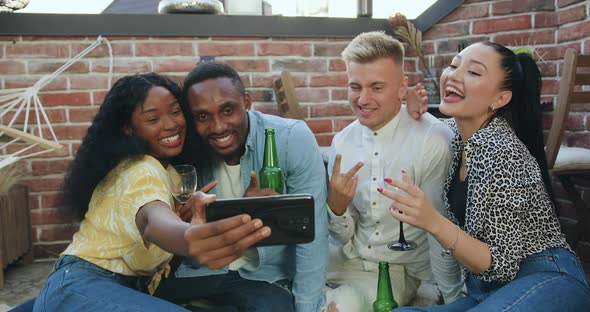 Friends which Making Selfie with Funny Faces During Summer Party on Terrace