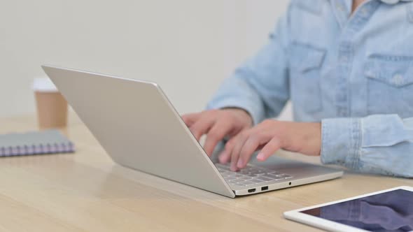 Close Up of Man Typing on Laptop