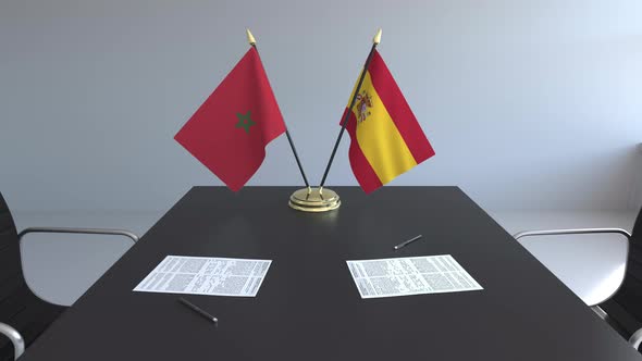 Flags of Morocco and Spain and Papers on the Table alt