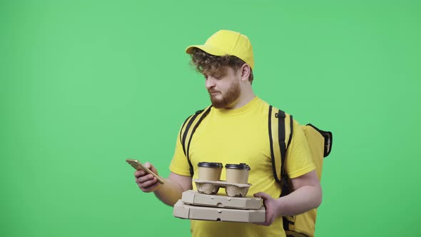Portrait of Men Holding Coffee and Pizza Specifying Delivery Address Using Smartphone