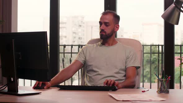 Young Businessman in Casual Clothes Working on the Computer