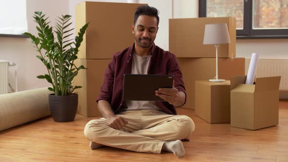 Man Having Video Call on Tablet Pc and Moving Home 