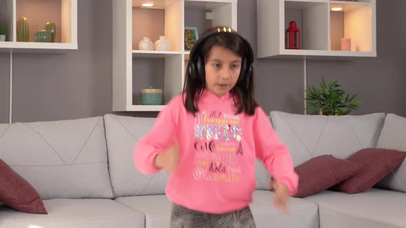 Little student dancing at home.