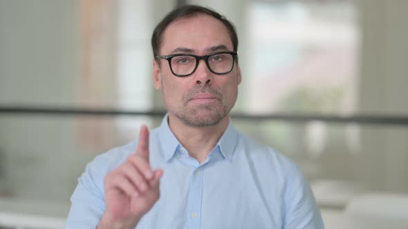 Middle Aged Man Showing No Sign By Finger Sign