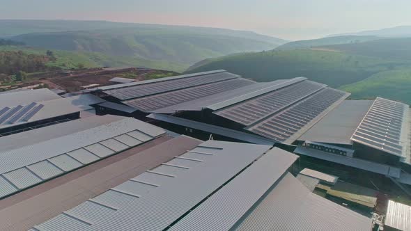 Aerial footage of large dairy farm with solar panels on the roofs