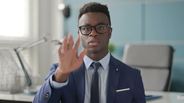 Portrait of African Businessman Showing Stop Sign By Hand