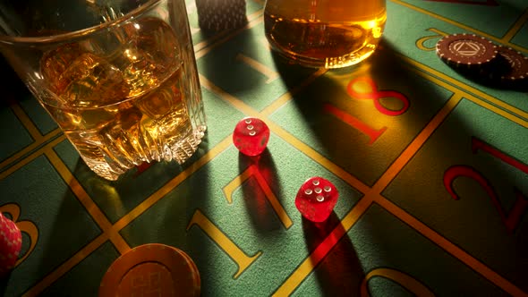A Man's Hand Puts a Glass of Whiskey on the Casino Table and Lays Down a Set of Three Ladies