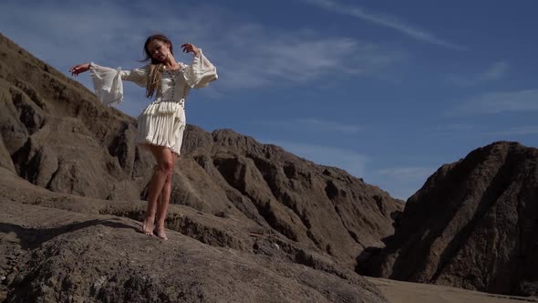 Young and Free Pretty Woman Is Posing in Sandy Rocks, Lady at Nature, Dramatic and Romantic Shot