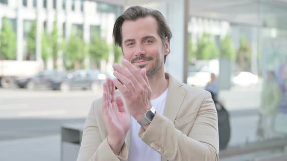 Young Man Clapping in Appreciation Outdoor