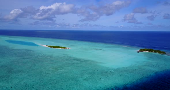 Tropical aerial tourism shot of a white sandy paradise beach and aqua blue water background 
