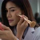 Close-up beautiful attractive young Asian woman doing makeup in the office - VideoHive Item for Sale