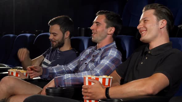 Group of Male Friends Watching Movies Together at the Cinema