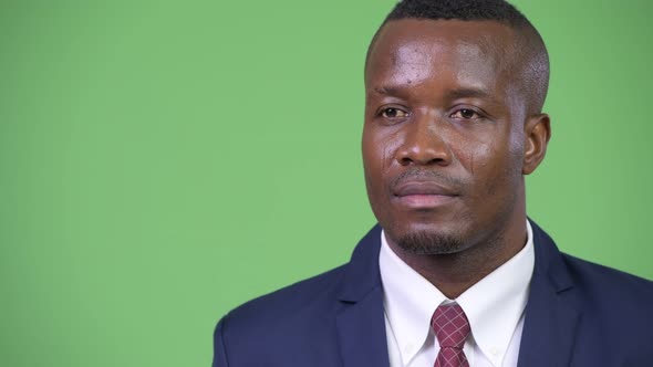 Young Happy African Businessman Smiling While Thinking