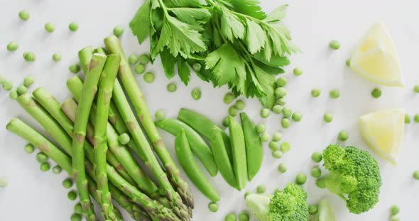 Video of close up of fresh green vegetables on white background