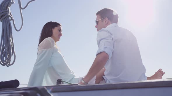 Young couple sit on sailboat together. Shot on RED EPIC for high quality 4K, UHD, Ultra HD resolutio