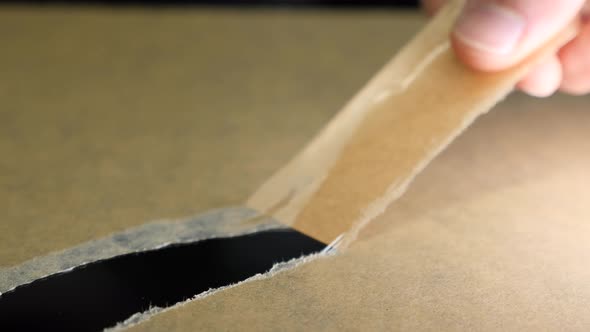 Hands peeling off adhesive paper