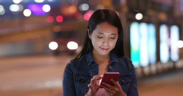 Woman Use of Mobile Phone in City at Night